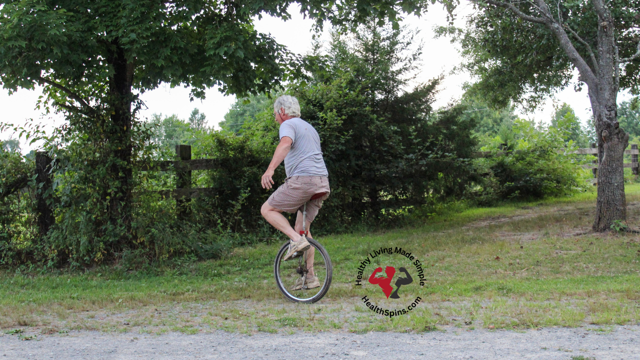 senior man balancing and pedaling a unicycle for the best balance exercise for seniors