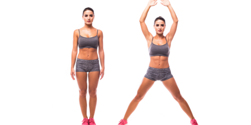 female with shorts and halter demonstrating jumping jacks for best exercise for heart at home